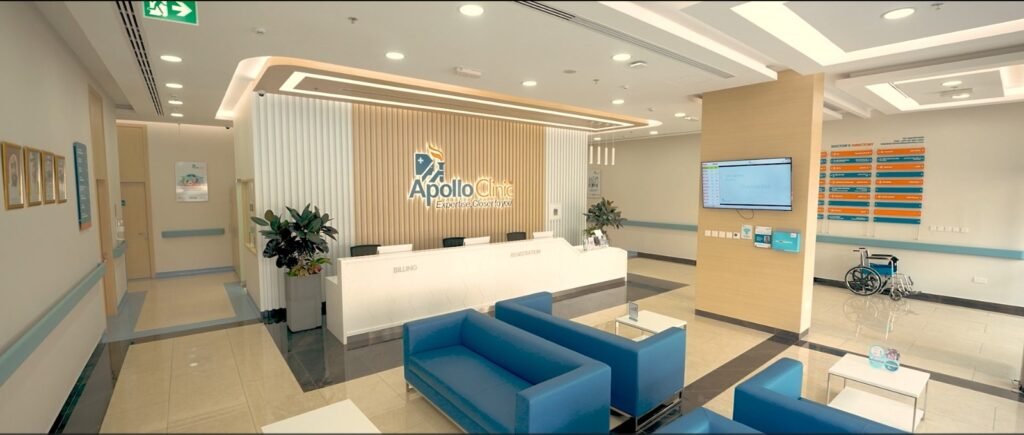 Modern clinic reception area with blue seating and a wheelchair.